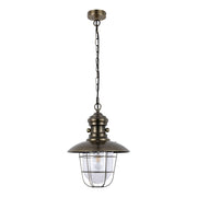 Antique brass pendant light with caged bulb design. An industrial, vintage style fixture hanging from a chain.