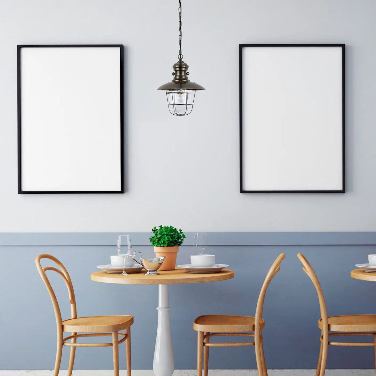 A stylish industrial pendant light fixture hanging above a set table, casting a warm glow in a contemporary dining space.