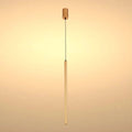 A modern, minimalist gold pendant light fixture with a long, slender cylindrical shade suspended from a black cable.