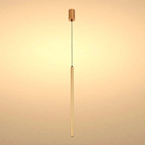 A modern, minimalist gold pendant light fixture with a long, slender cylindrical shade suspended from a black cable.