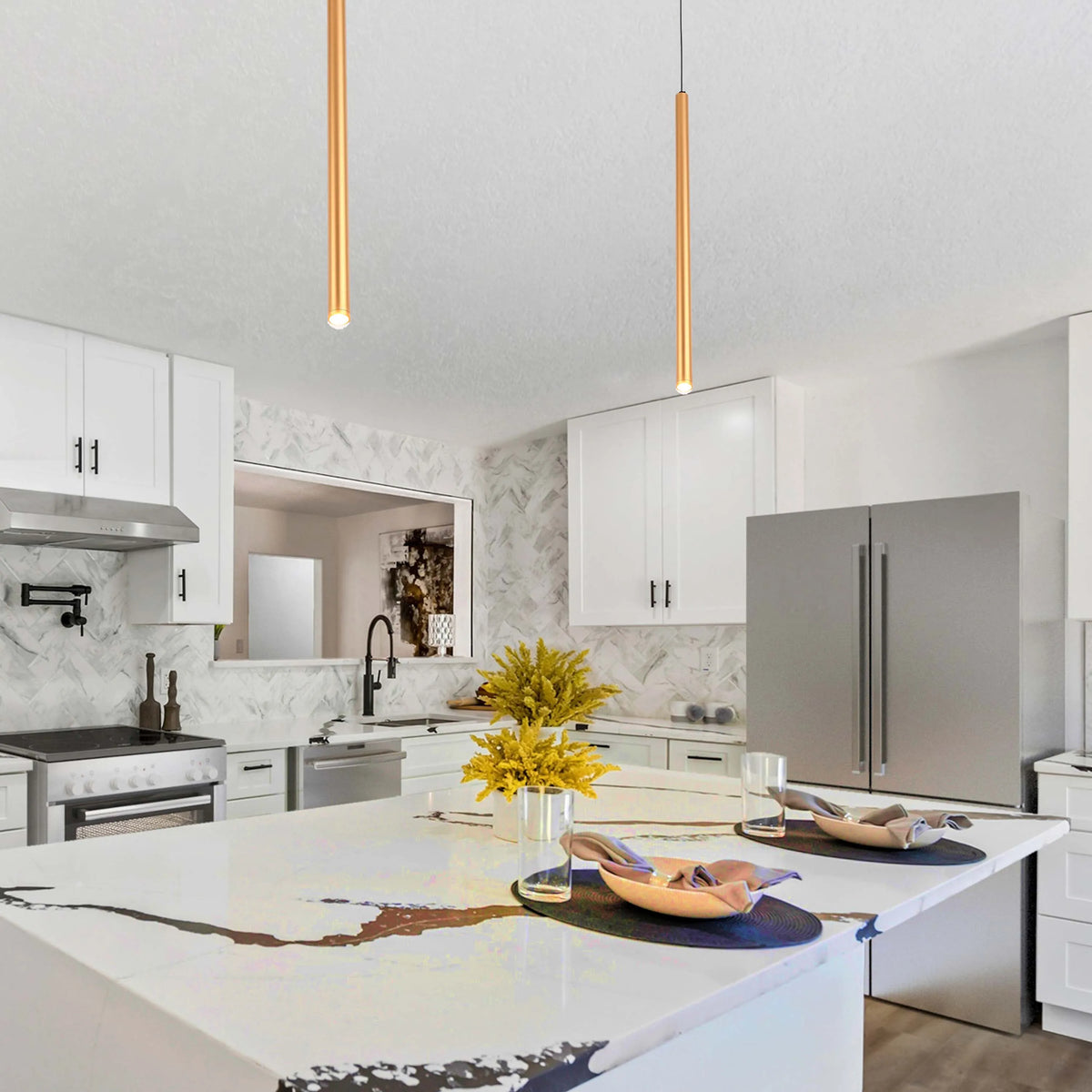 Two pendant lights hang above a kitchen island, illuminating the space with focused downlighting in a modern kitchen setting.