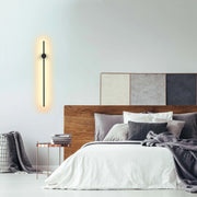 Modern, slimline black wall light providing a warm glow. Minimalist design for contemporary interior spaces.