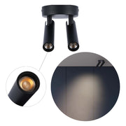 A sleek, modern black spotlight fitting with two adjustable lights, casting a warm glow. Ideal for accent lighting.