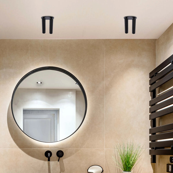 Bathroom with recessed ceiling lights, backlit mirror, and wall-mounted heated towel rail, illuminating the space in a modern style.