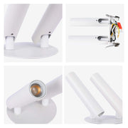 A modern white spotlight with two cylindrical heads on a round base, offering adjustable, focused illumination.