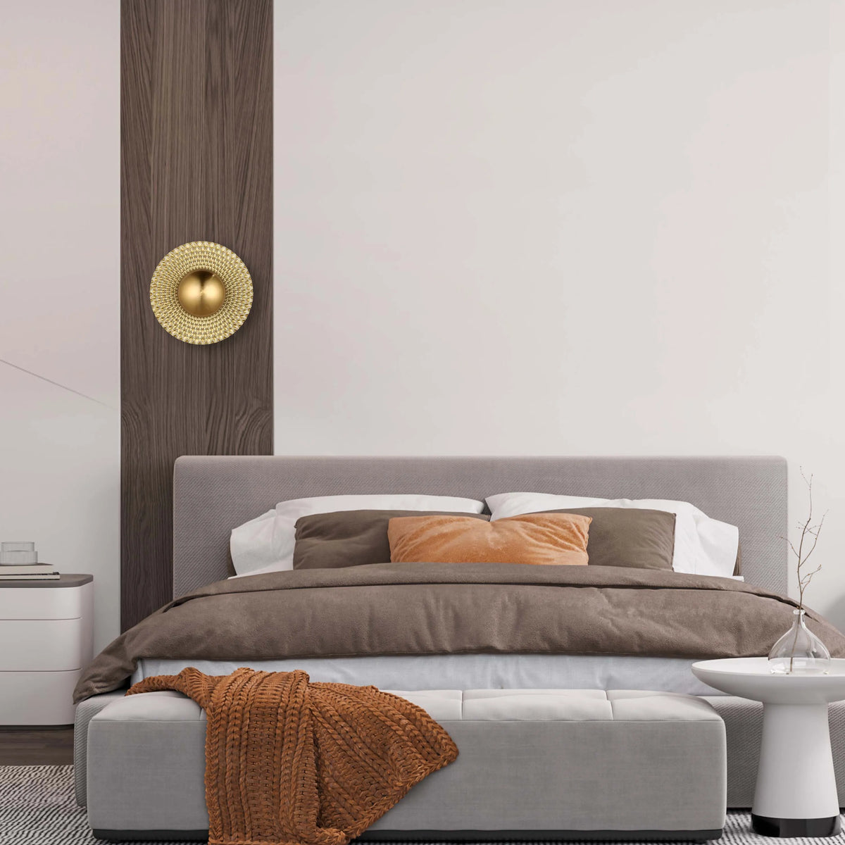 Interior shot with warm neutral lighting, featuring a golden round wall light, casting a soft glow in the bedroom.
