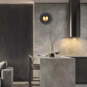 Contemporary lighting on display: a spherical, gold wall light alongside sleek, integrated ceiling lights create a modern ambiance.