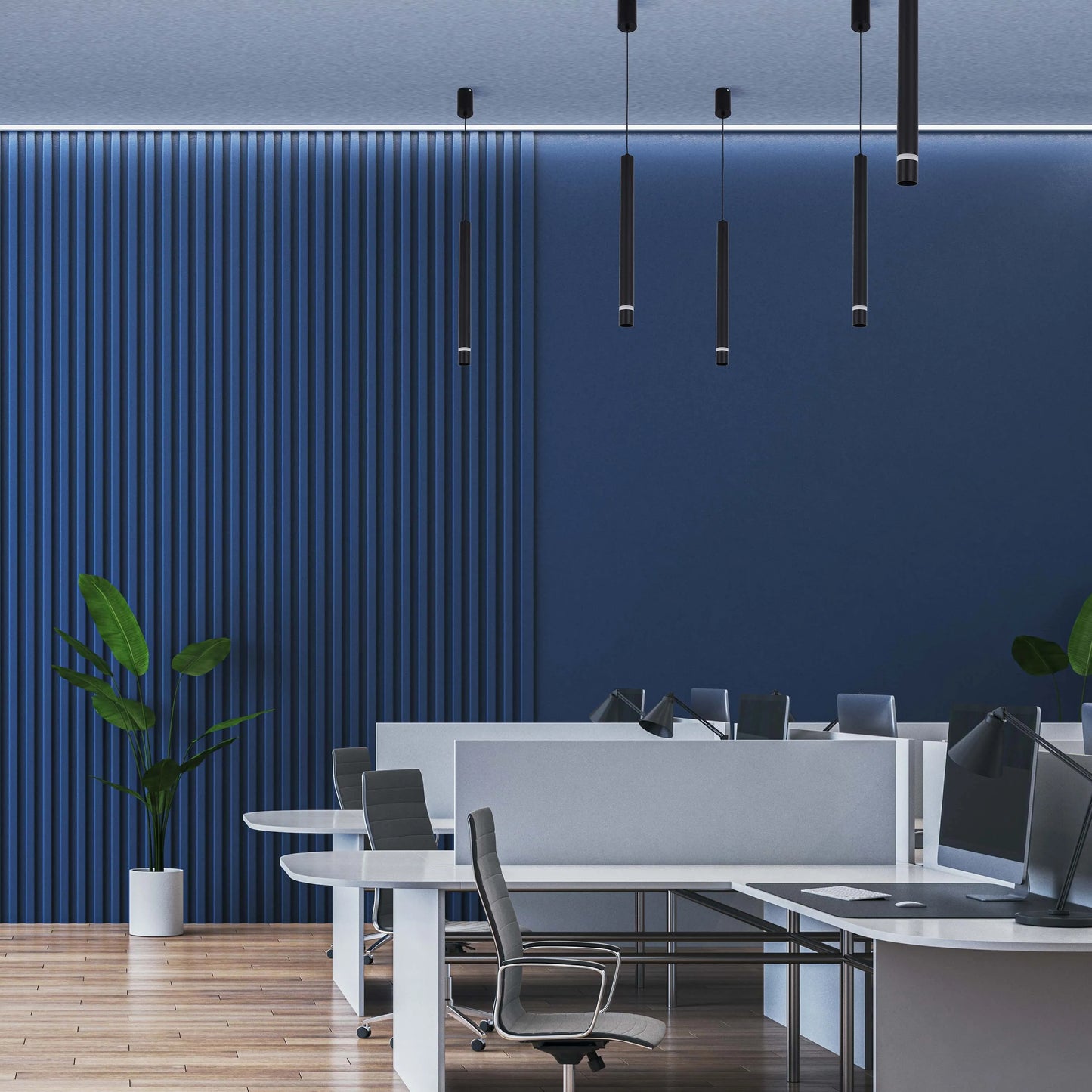 Pendant lighting in a modern office space, with cylindrical shades suspended from the ceiling.