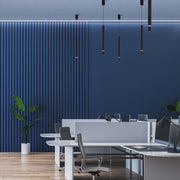 Pendant lighting in a modern office space, with cylindrical shades suspended from the ceiling.