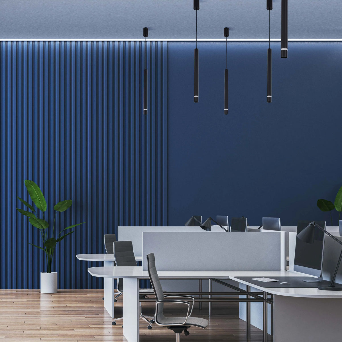 Pendant lighting in a modern office space, with cylindrical shades suspended from the ceiling.