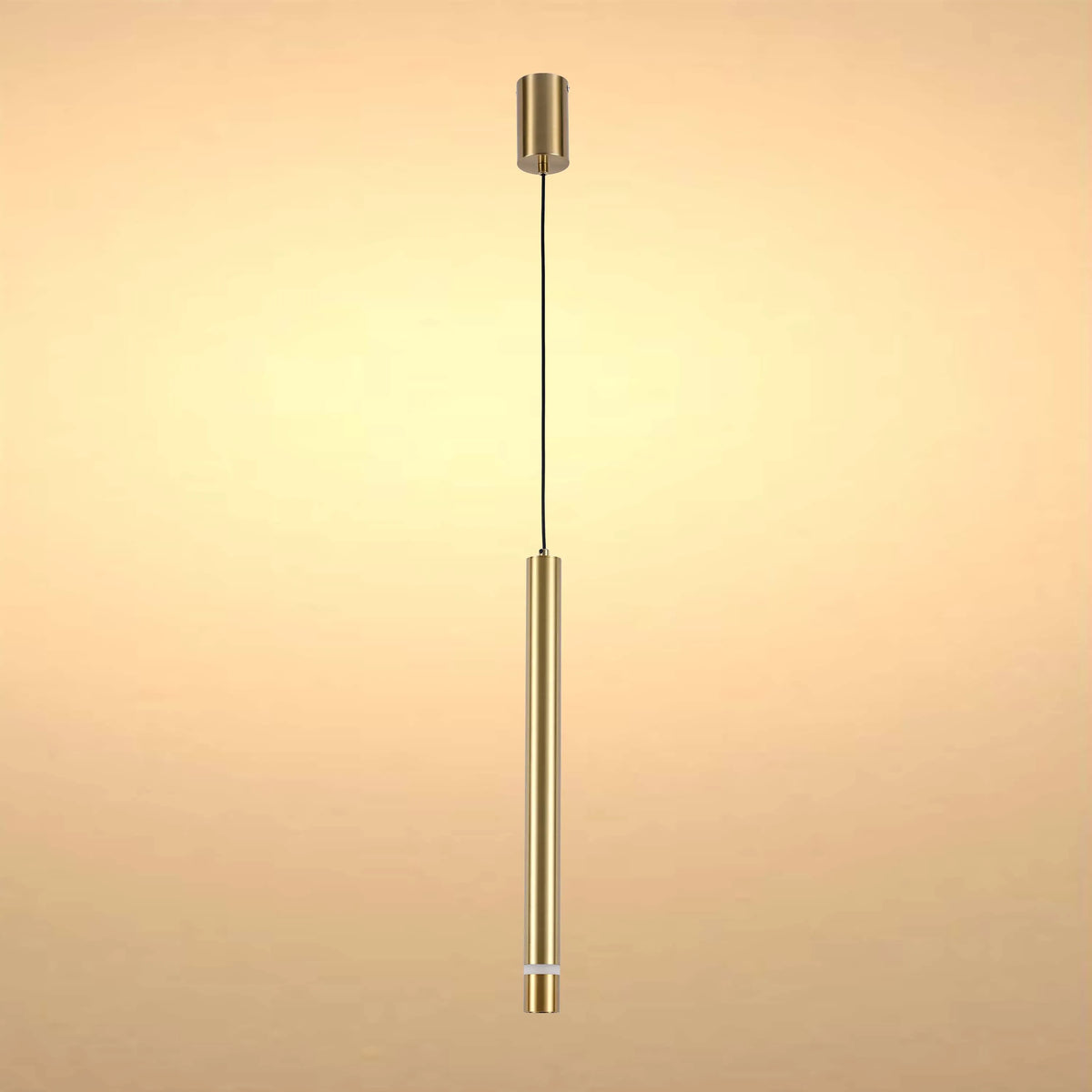 A brushed gold pendant light hangs against a subtle gold backdrop, simple and modern.