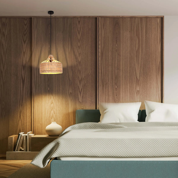 Cosy bedroom with rattan pendant light illuminating a wooden headboard and neatly made bed. The light adds warmth to the room.