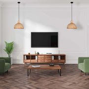 Living room featuring two straw pendant lights hanging from the ceiling, casting a warm, natural light over the stylish setup.