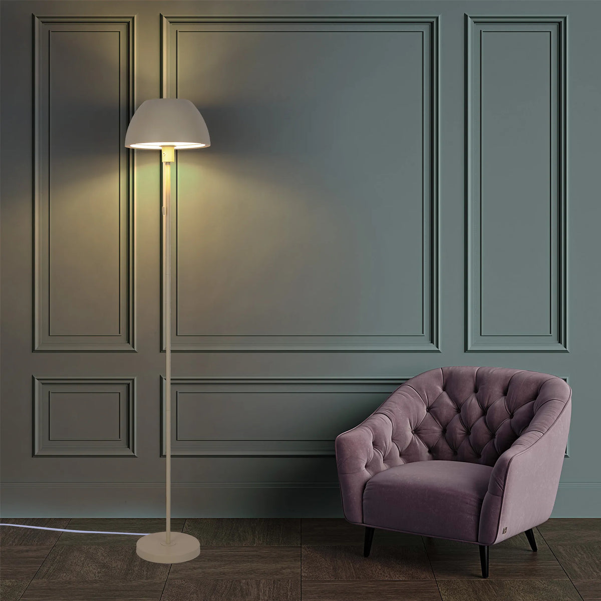 Floor lamp illuminates the room, creating a warm glow against the dark teal walls and highlighting the mauve chair.