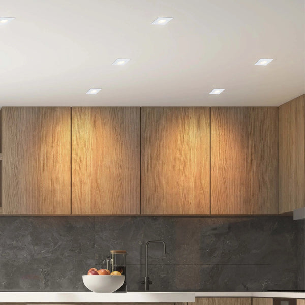 Modern kitchen lighting featuring recessed square downlights providing bright, ambient light, complementing the sleek, contemporary design.