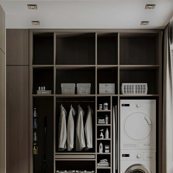 Square recessed ceiling lights provide a modern and functional lighting solution for a laundry and storage space.