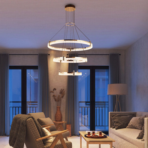 Modern living room with round chandelier hanging above a couch and chair with curtains, and natural light streaming through balcony doors.