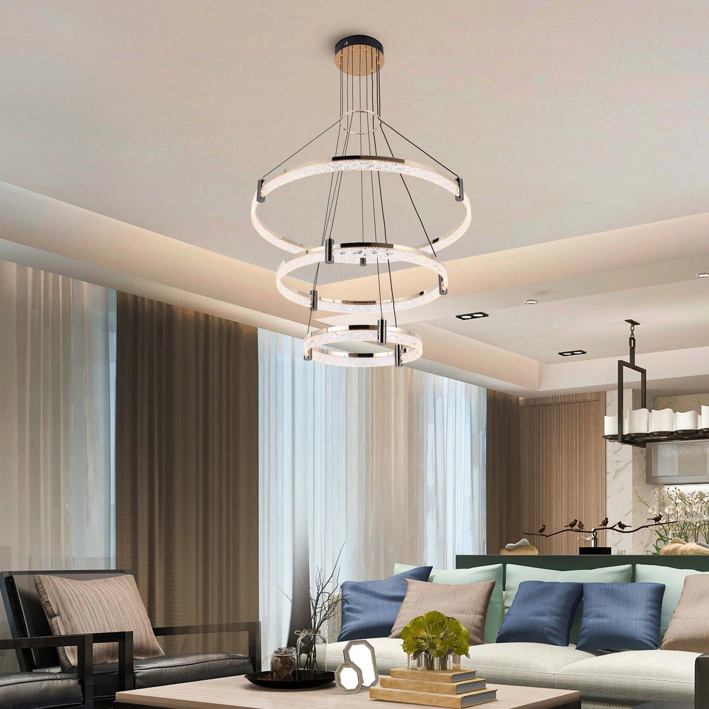 A contemporary multi-tier LED chandelier with crystal accents illuminates this stylish living space.