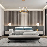 Bedroom lighting features modern chandelier, globe bedside lamps, and recessed ceiling lights, creating a stylish and well-lit space.