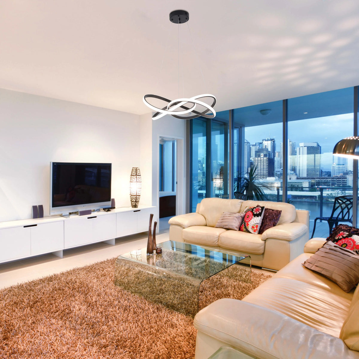 Contemporary living room featuring a striking circular pendant light in black and white, providing ambient illumination.