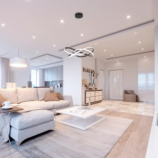 Contemporary living room showcasing a sculptural, ring-shaped pendant light, plus recessed ceiling lights.