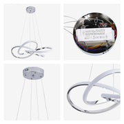 A modern, circular LED pendant light with a chrome finish, suspended by wires from a circular ceiling mount.