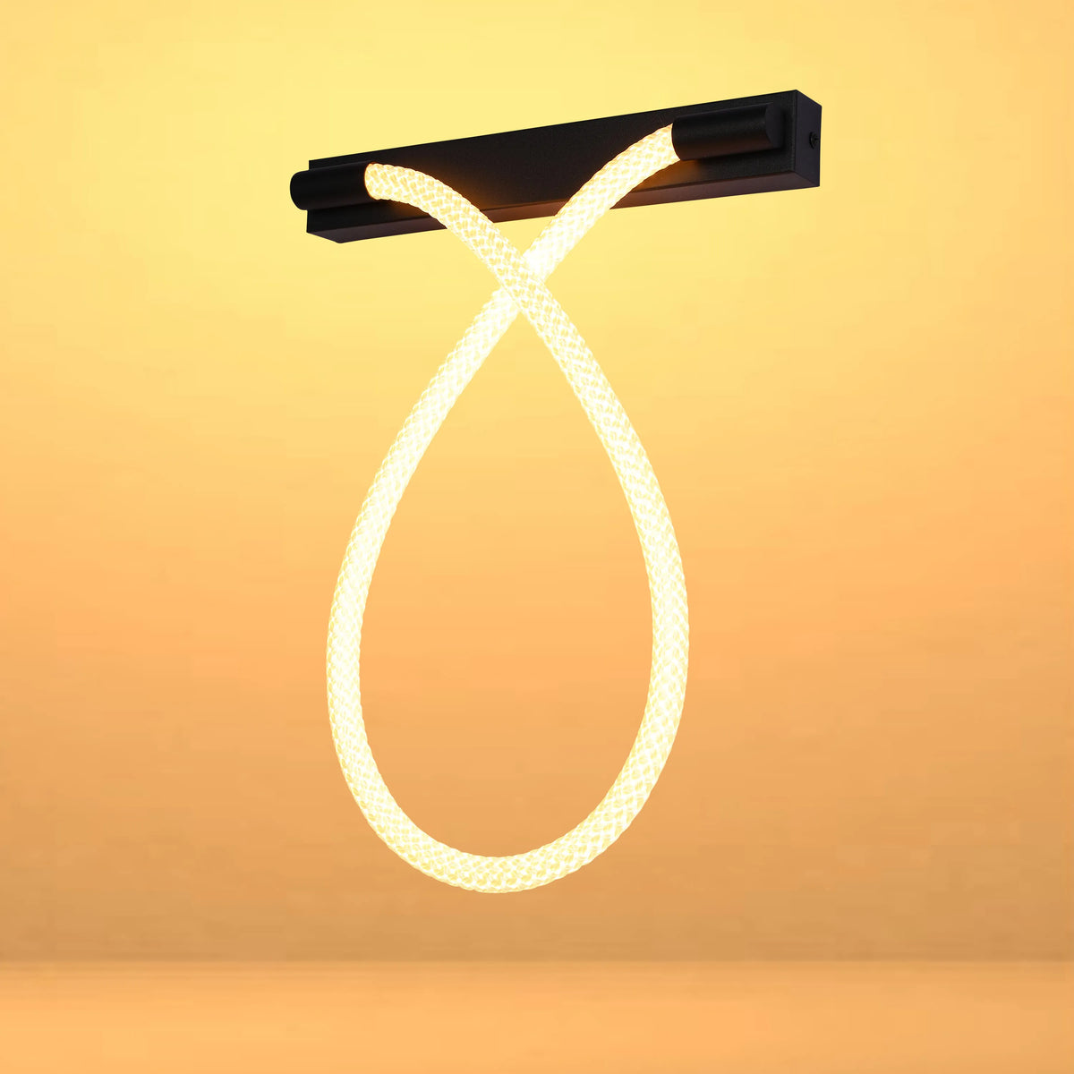 A looping LED rope light fixture mounted on a sleek, dark base, radiating a warm, inviting glow.