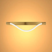 A modern light fitting with a gold fixture and a white rope element, casting a warm and inviting glow.