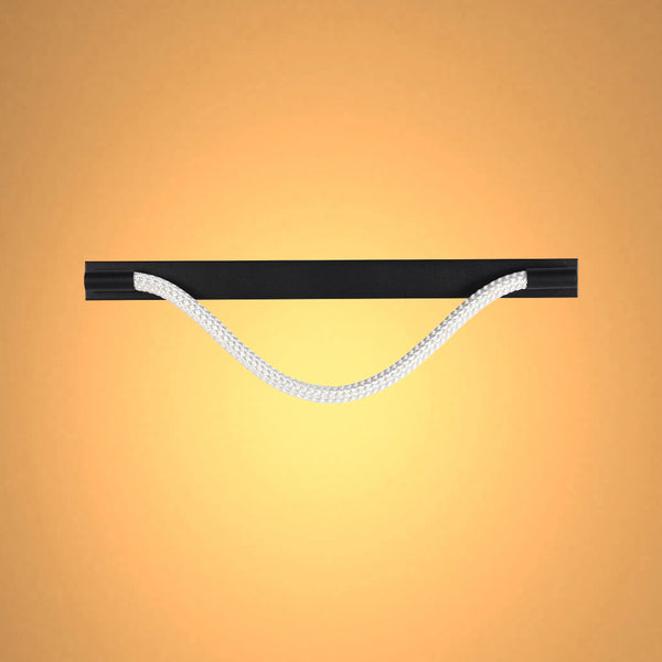 A soft, diffused light accentuates the black horizontal fixture, contrasting beautifully with the light rope handle against a warm-toned backdrop.