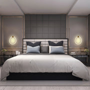 Symmetrical bedroom design featuring wall-mounted circular lights, bedside lamps, and a diffused light source from the ceiling.