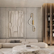 A sleek, modern wall light with gold metal accents and a curved, white LED strip creates a stylish and contemporary ambience.