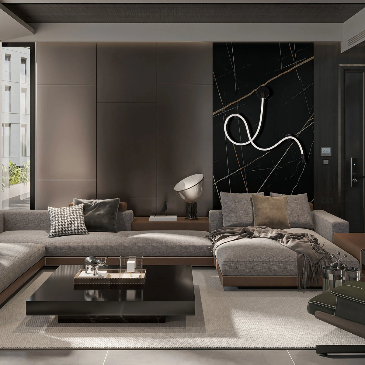 A modern living room with a statement black marble wall featuring a unique coiled white LED wall light.