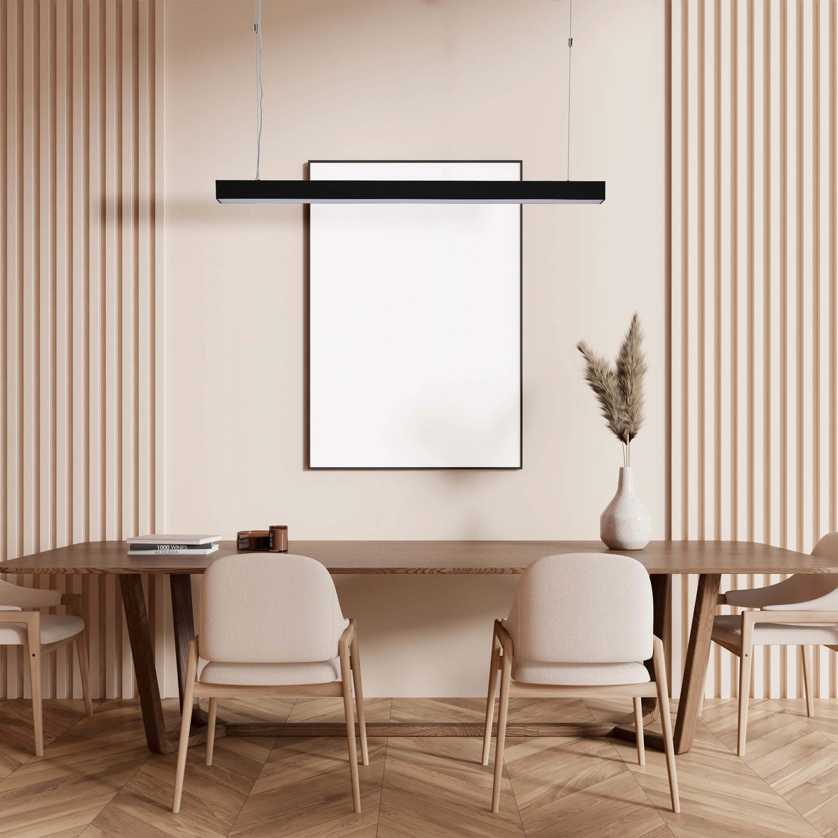 A sleek, modern black pendant light hangs above a wooden dining table with neutral chairs, adding a touch of sophistication to the room.