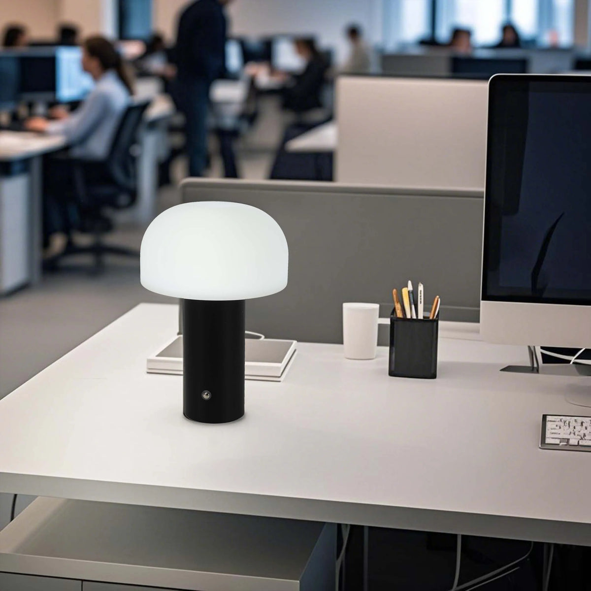 Stylish mushroom-shaped lamp on a desk, providing soft ambient lighting. A modern touch to office spaces.