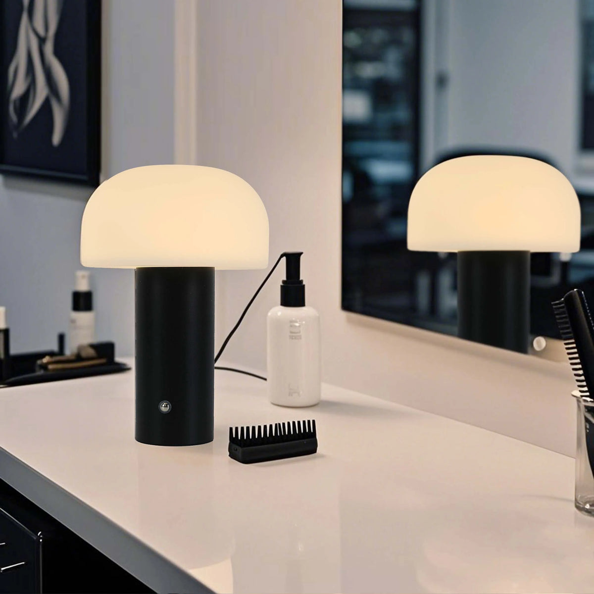 A mushroom-shaped table lamp emitting a soft, warm glow in a modern bathroom setting. It has a white dome and a sleek black base.