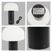 A modern mushroom lamp with a white dome shade and a black cylindrical base, USB charging cable visible.