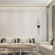 Ambient lighting from recessed spotlights and a unique black and gold wall sconce create a modern, stylish living space.
