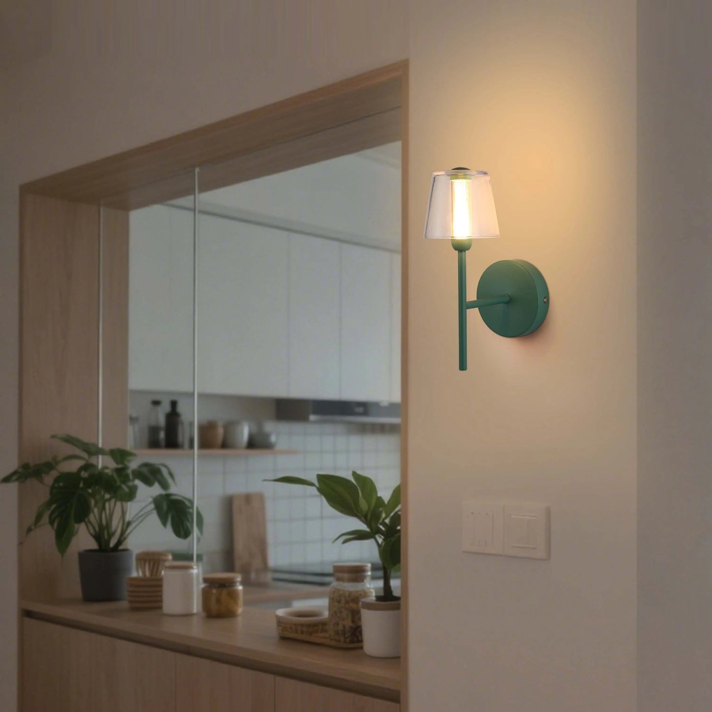 Green wall sconce casts a warm, inviting light. Simple, modern design for a touch of elegance in any room.