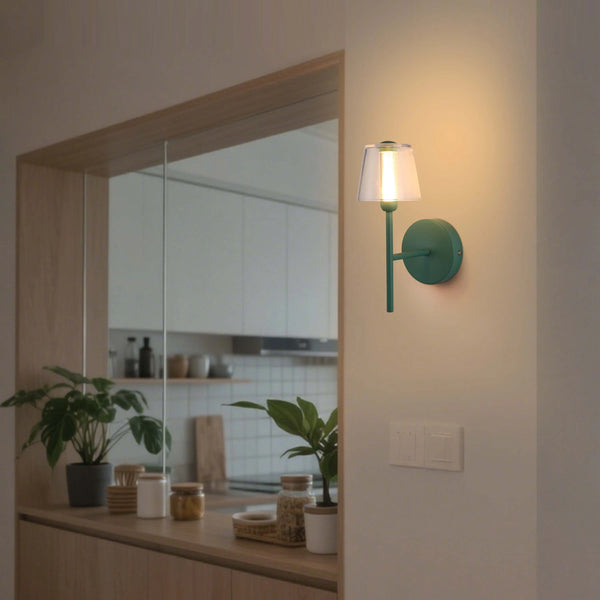 Green wall sconce casts a warm, inviting light. Simple, modern design for a touch of elegance in any room.