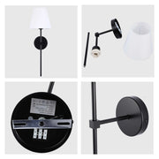 A modern black wall lamp with a white fabric lampshade, featuring a minimalist design and adjustable arm.