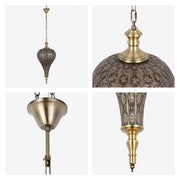 A decorative bronze metal pendant light fixture with intricate cut out patterns, hanging from a chain.