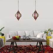Moroccan-style hanging pendants provide warm ambient lighting in this bright, airy living room setting.