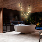 Striking, modern kitchen lighting. Features a unique, spherical chandelier that casts a warm glow, enhancing the room's luxurious feel.