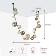 A glamorous ceiling light with smoked glass baubles suspended on a black cable. Dimensions for height and width shown.