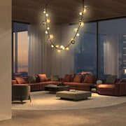 Stylish statement lighting takes centre stage in this contemporary living room featuring statement bubble chandelier.