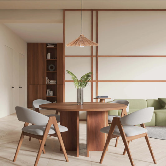Straw pendant light shines above a wooden dining table, creating a warm and inviting atmosphere in this modern dining space.
