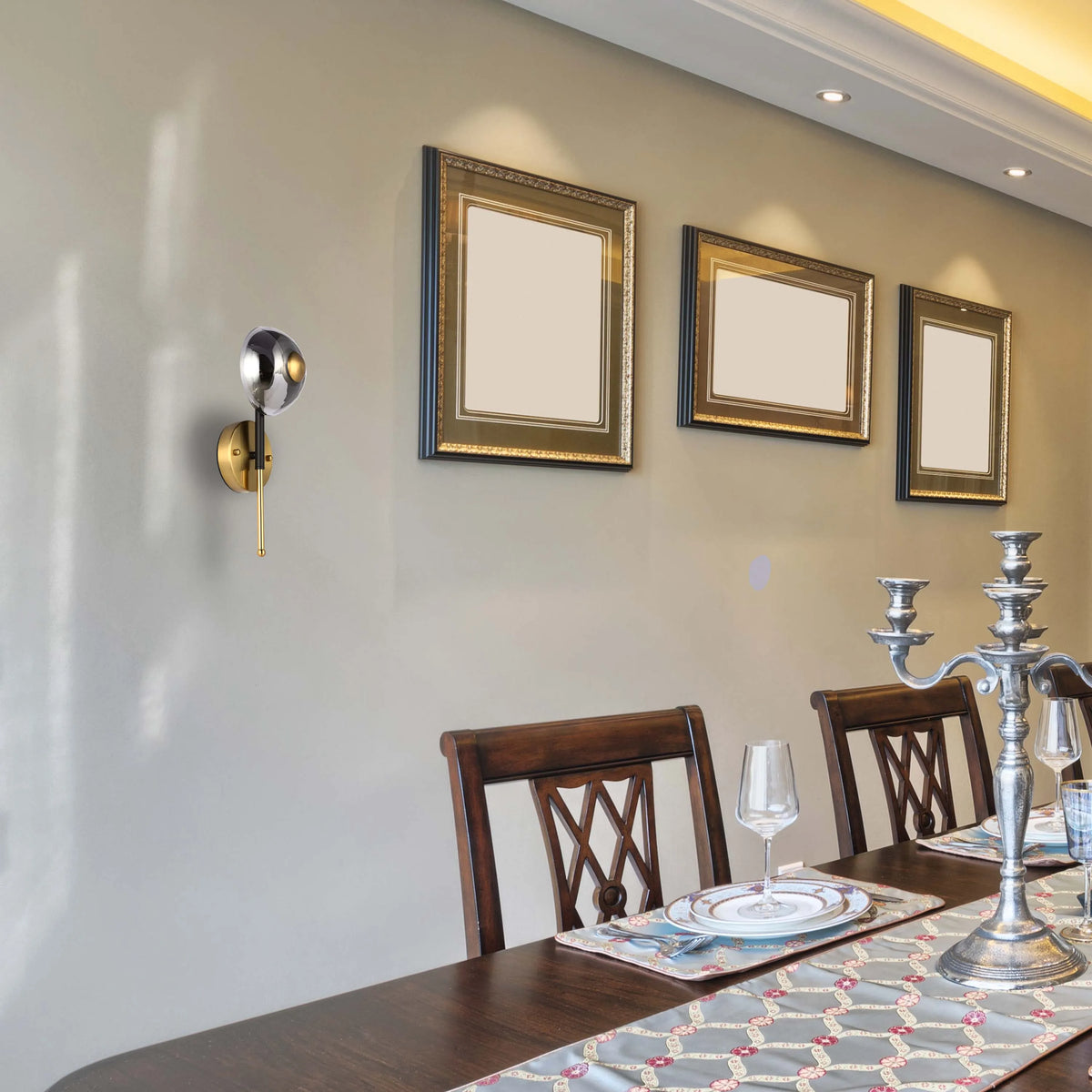 Wall-mounted globe light plus recessed ceiling lights illuminate the dining area, enhancing the ambience.