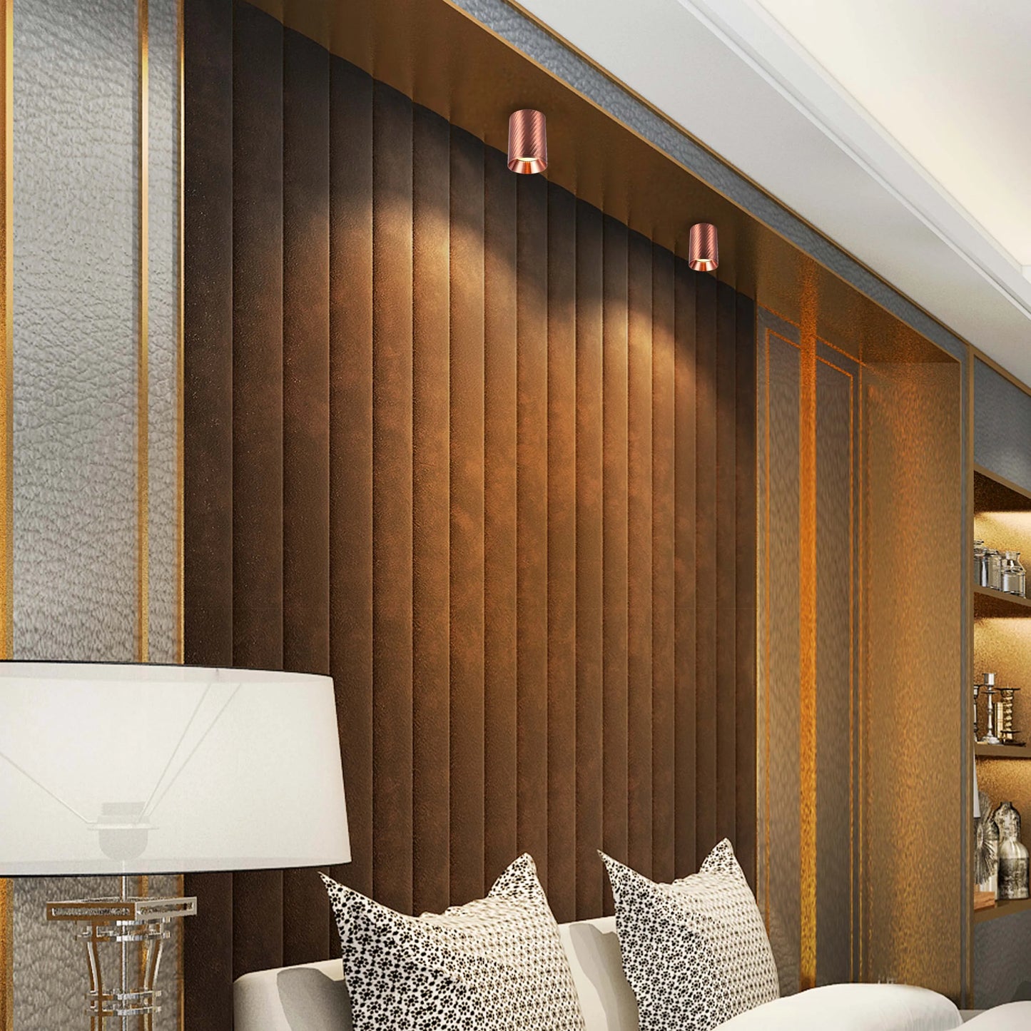 Bedroom wall lights are shining downwards on a brown headboard, creating mood lighting in the room.