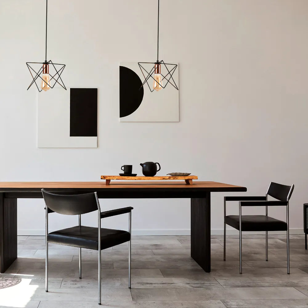 Elegant rose gold and black metal cage pendant light perfectly complements a modern dining room with industrial decor.159-17026