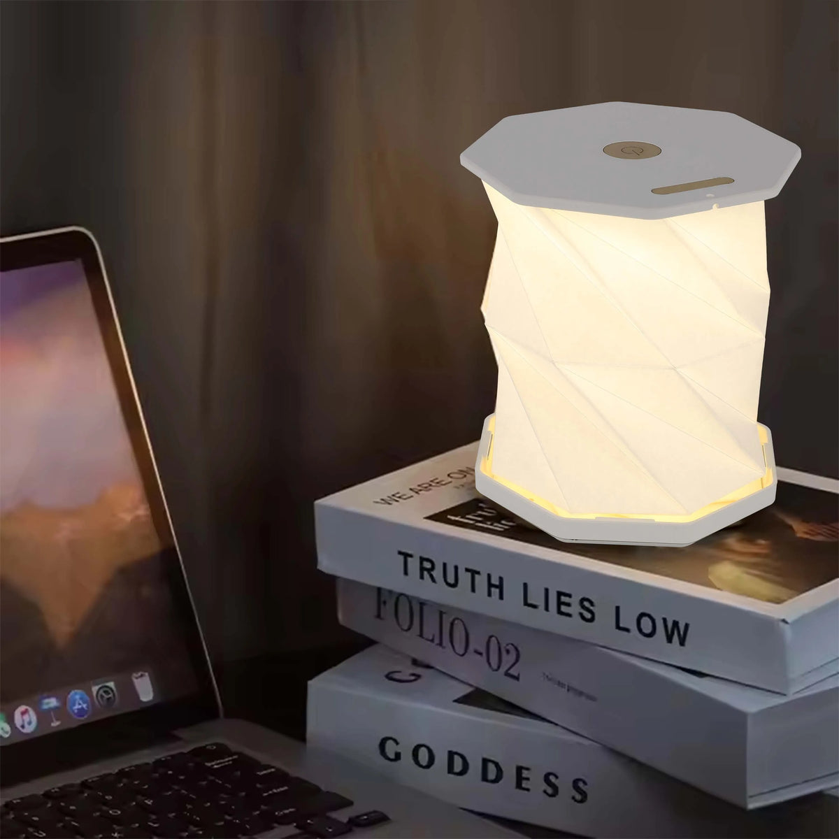 A hexagonal LED lamp sits atop a stack of books. It emits a warm, ambient light, creating a cosy atmosphere.